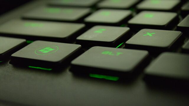 close up photography of black and green computer keyboard keys